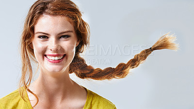 Buy stock photo Cropped studio portrait of a happy and beautiful young woman with braided hair 