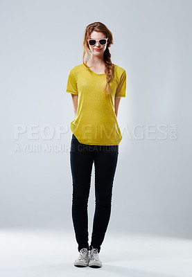 Buy stock photo Full-length studio portrait of an attractive young woman wearing trendy sunglasses