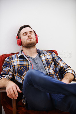 Buy stock photo Man, headphones and nap in living room with music, song or podcast to relax on the weekend at home. Audio, streaming and internet radio with calm track in chair with digital and online listening