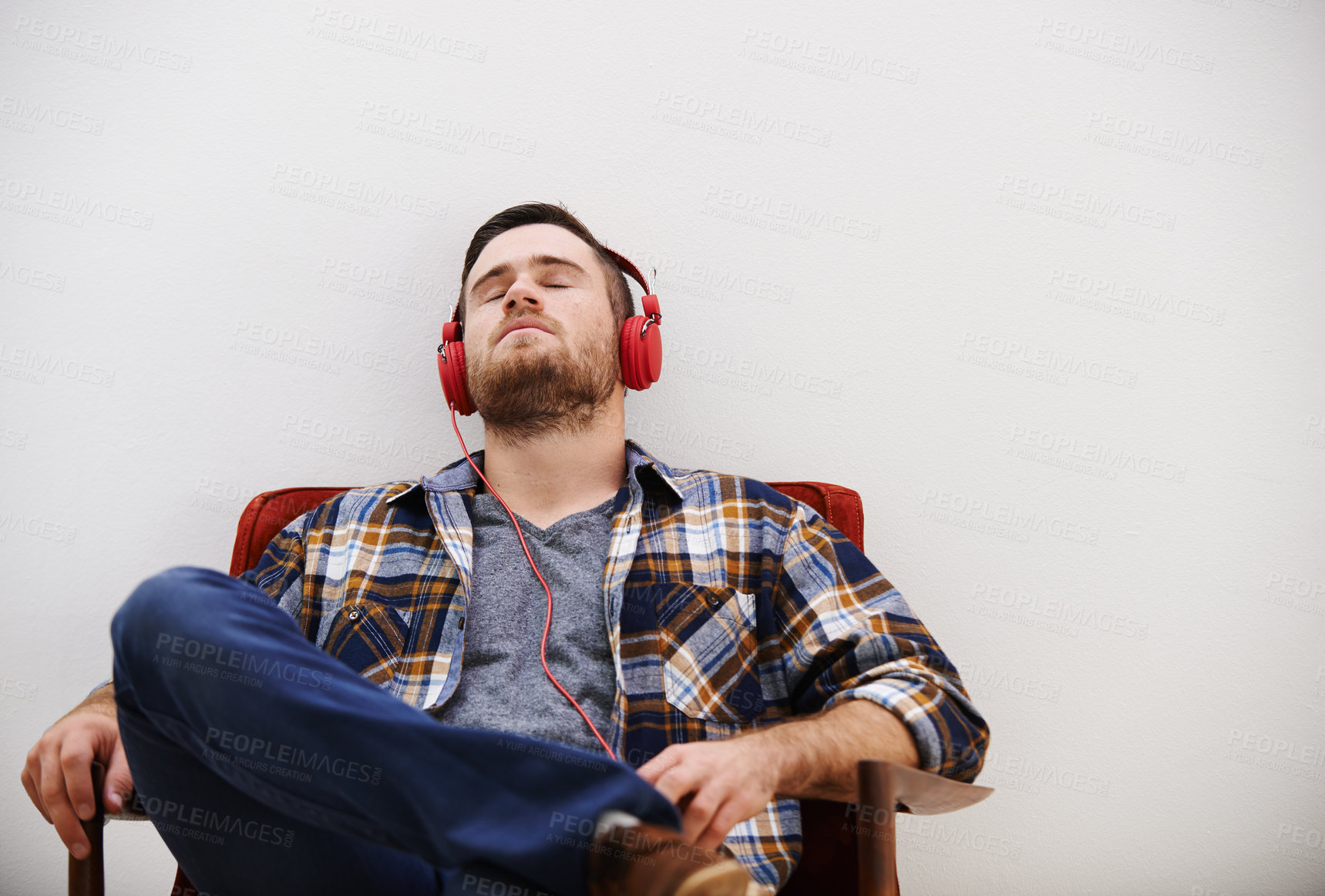 Buy stock photo Man, headphones and relax in living room with music, song or podcast to rest on the weekend at home. Audio, streaming and internet radio with calm track in chair with digital and online listening