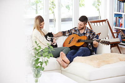 Buy stock photo Happy people, home and playing guitar for fun, together and relationship with love, support or care  Woman, man and music instrument for bonding, relax and joy in lounge for session, peace and memory