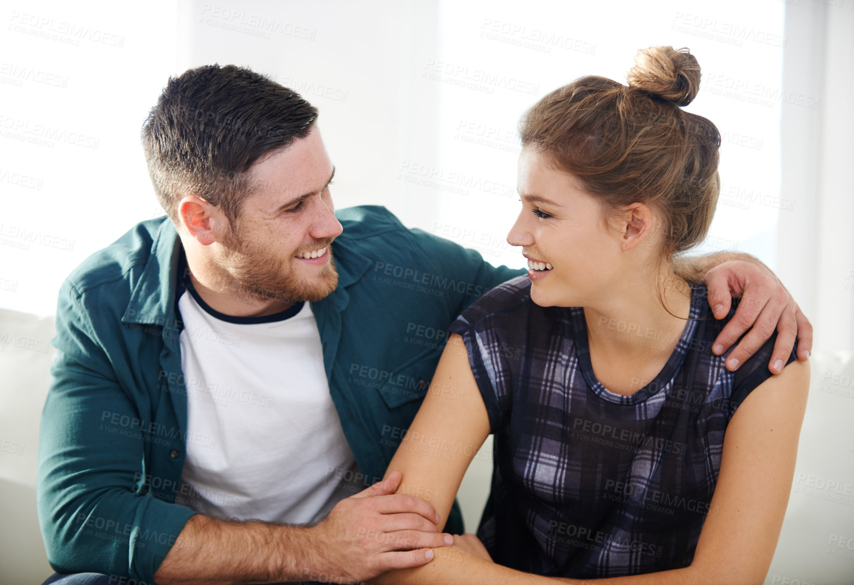 Buy stock photo Love, smile and couple hug in home for trust, care and support on living room sofa. Happy man, woman and embrace for connection, commitment and loyalty with partner for healthy relationship together