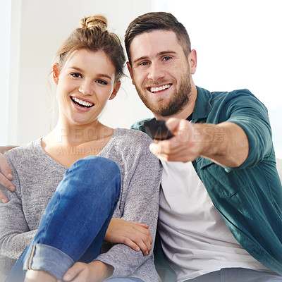Buy stock photo Relax, laughing and happy couple watching tv in house for movie choice, streaming service and chill. Television, man and funny woman in living room for drama show, comedy and change channel in home