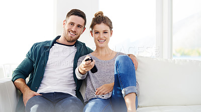 Buy stock photo Happy couple, relax and watching tv in home for movie, streaming service and chill. Television, man and woman smile in living room for drama show, film and change channel for series on sofa together