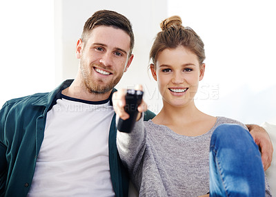 Buy stock photo Happy couple, relax and watching tv in house for movie, streaming service and chill. Television, man and woman smile in living room for drama show, film and change channel for series on sofa together