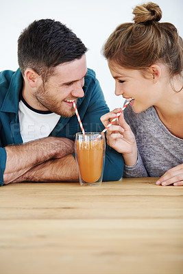 Buy stock photo Smile milkshake and cafe with couple on date for romance, bonding and happiness. Smoothie, coffee shop and care with man and woman sharing drink at restaurant for summer, break and relationship