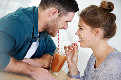 Buy stock photo Love, milkshake and drink with couple on date for romance, bonding and happiness. Smoothie, coffee shop and care with man and woman sharing at cafe restaurant for summer, break and relationship