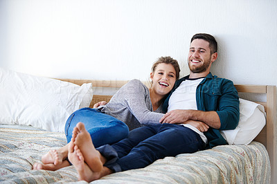 Buy stock photo Happy couple, bedroom and hug to relax with conversation, laughing and funny humor for love. People, embrace and trust in commitment to relationship in home, talking and comfortable together in bed