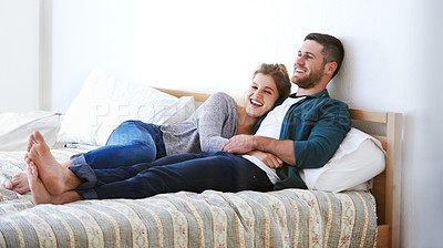 Buy stock photo Happy couple, bedroom and hug to relax with communication, laugh and funny humor for love. People, embrace and trust in commitment to relationship in home, talking and comfortable together in bed