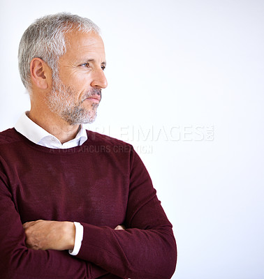 Buy stock photo Shot of a handsome mature business looking thoughtful against a white background