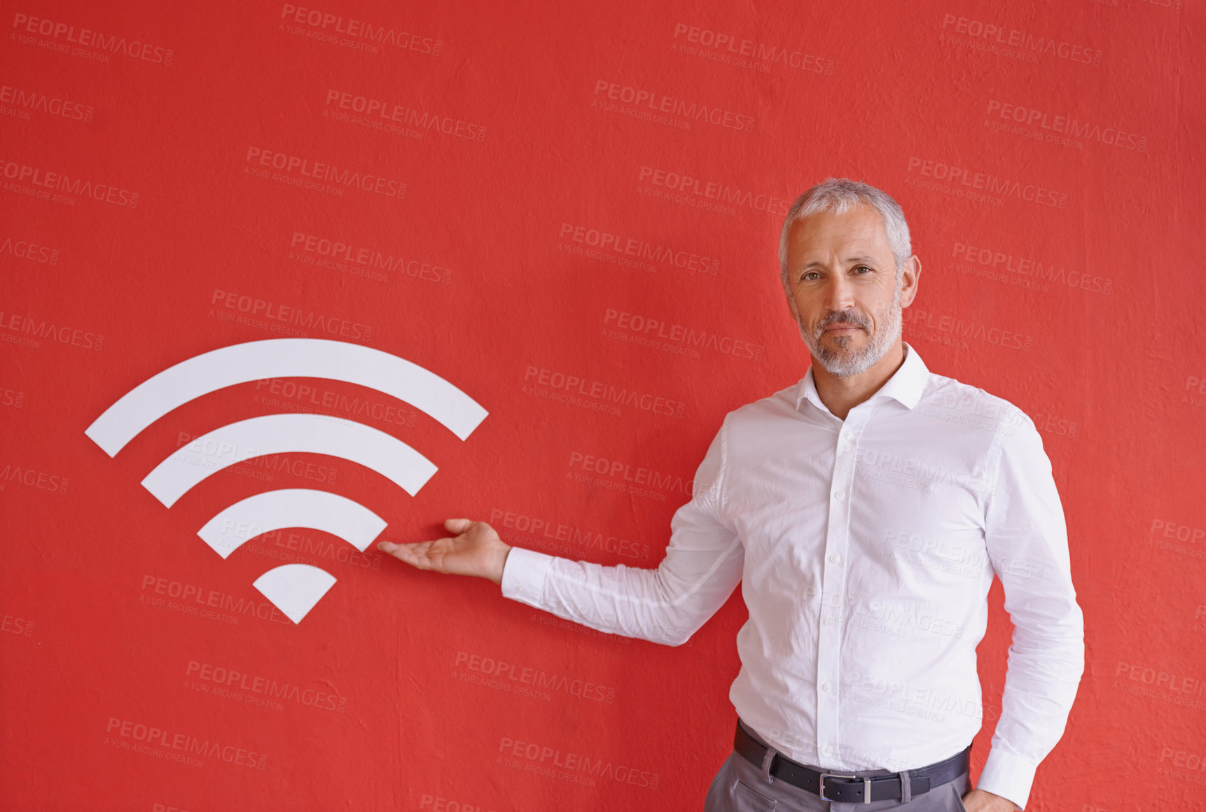 Buy stock photo Businessman, wall and icon for wireless connection with portrait, smile and choice by red background. Mature person, point and presentation with sign, symbol and review at company for fast internet