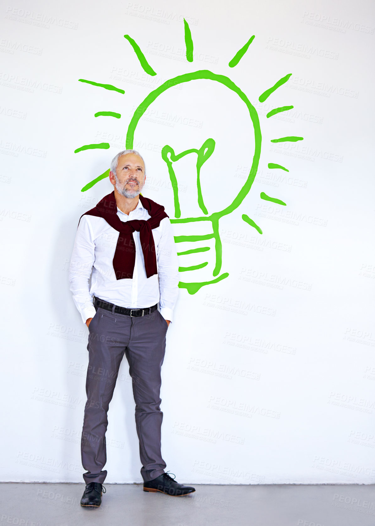 Buy stock photo Mature businessman, thinking and wall with lightbulb symbol in modern office with inspiration, solution or vision. Person, ideas and process with sign, icon and emoji at renewable energy company