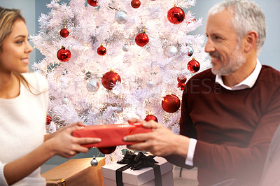 Buy stock photo Shot of a father and daughter exchanging gifts at Christmas