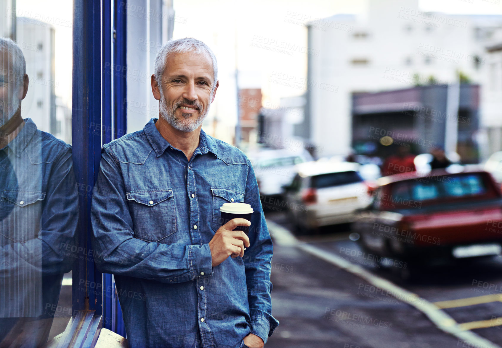 Buy stock photo Portrait of a handsome mature man drinking takeaway coffee while out in the city