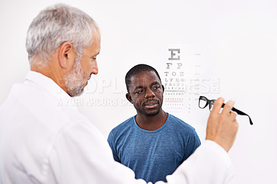 Buy stock photo Optometrist, glasses and man with help in office for eyesight, examination and consultation service. Optometry, client and people fitting with lens in frame for optical health, vision and assessment