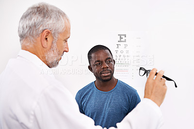 Buy stock photo Cropped shot of an optometrist testing a patient's eyesight