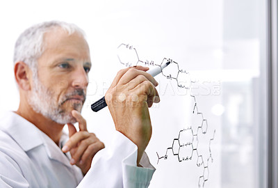 Buy stock photo Shot of a mature male scientist drawing a molecular structure on a glass surface