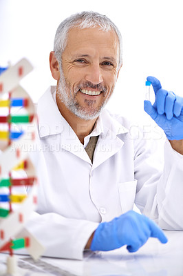 Buy stock photo Portrait of a mature male scientist holding a medical sample in his lab