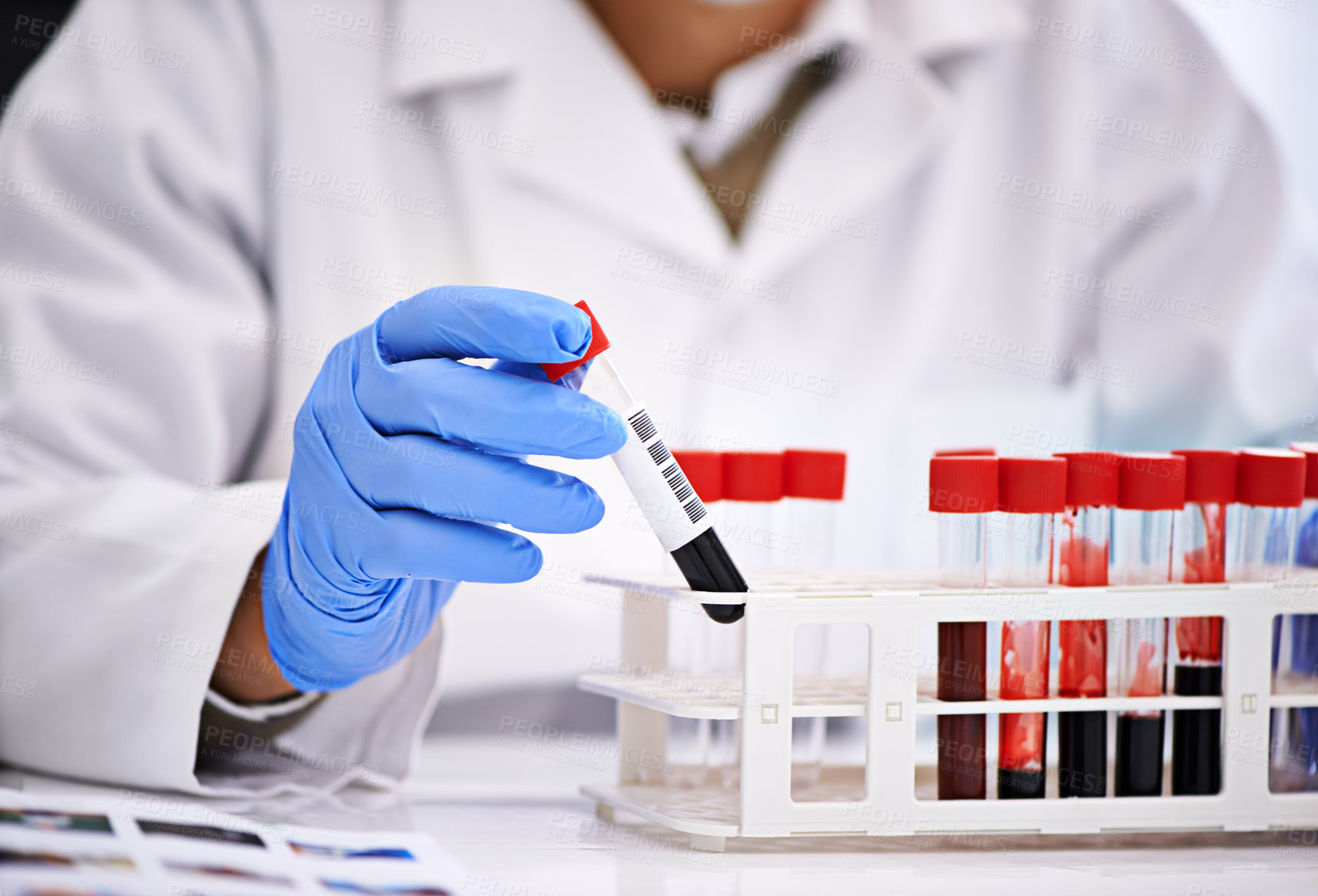 Buy stock photo Cropped shot of a male scientist conducting blood tests in a medical lab