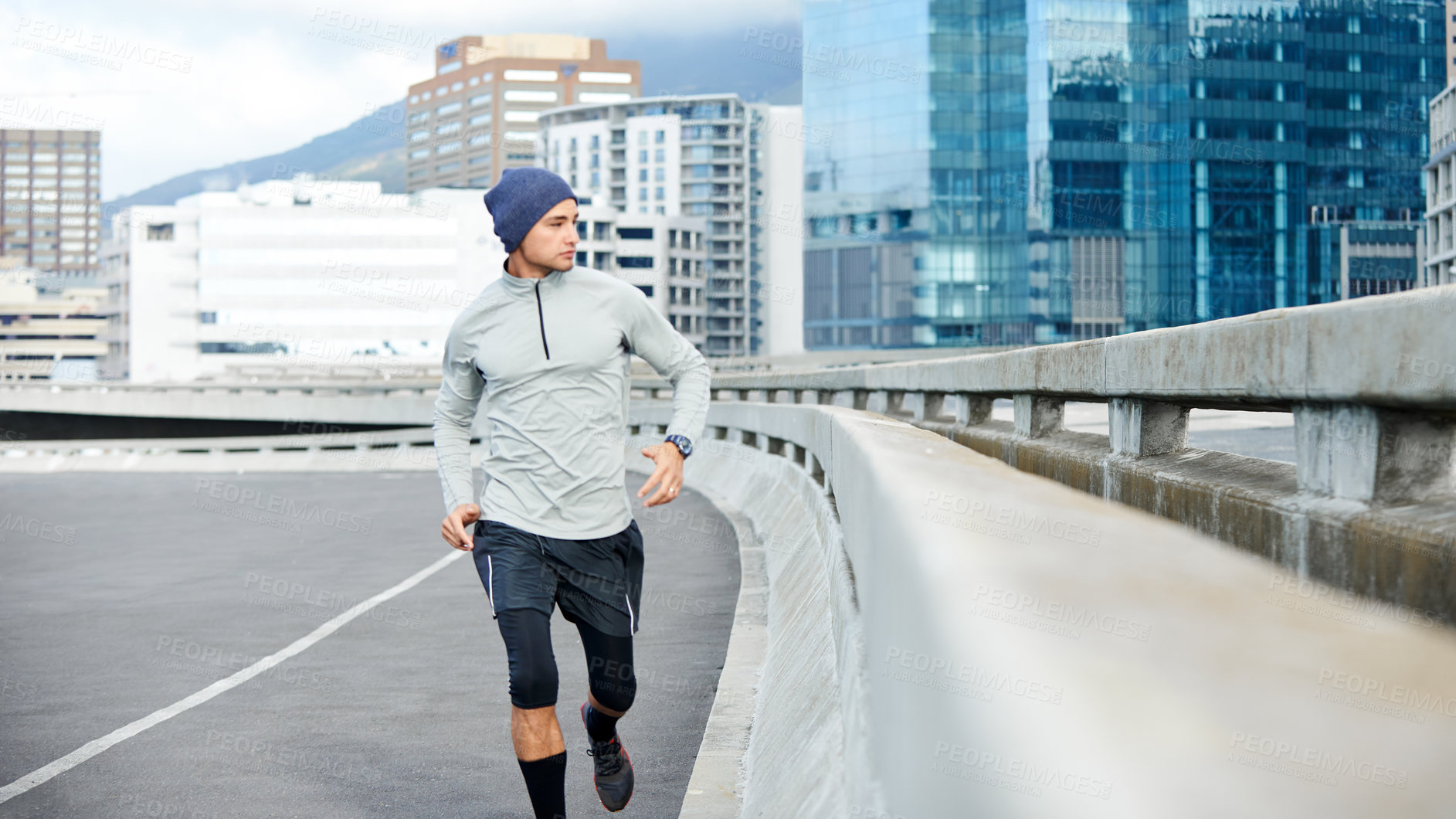 Buy stock photo Fitness, running and man in city for training, exercise or cardio for healthy body. Sports, jog and runner on street outdoor for wellness, energy or workout to lose weight or race in winter on bridge