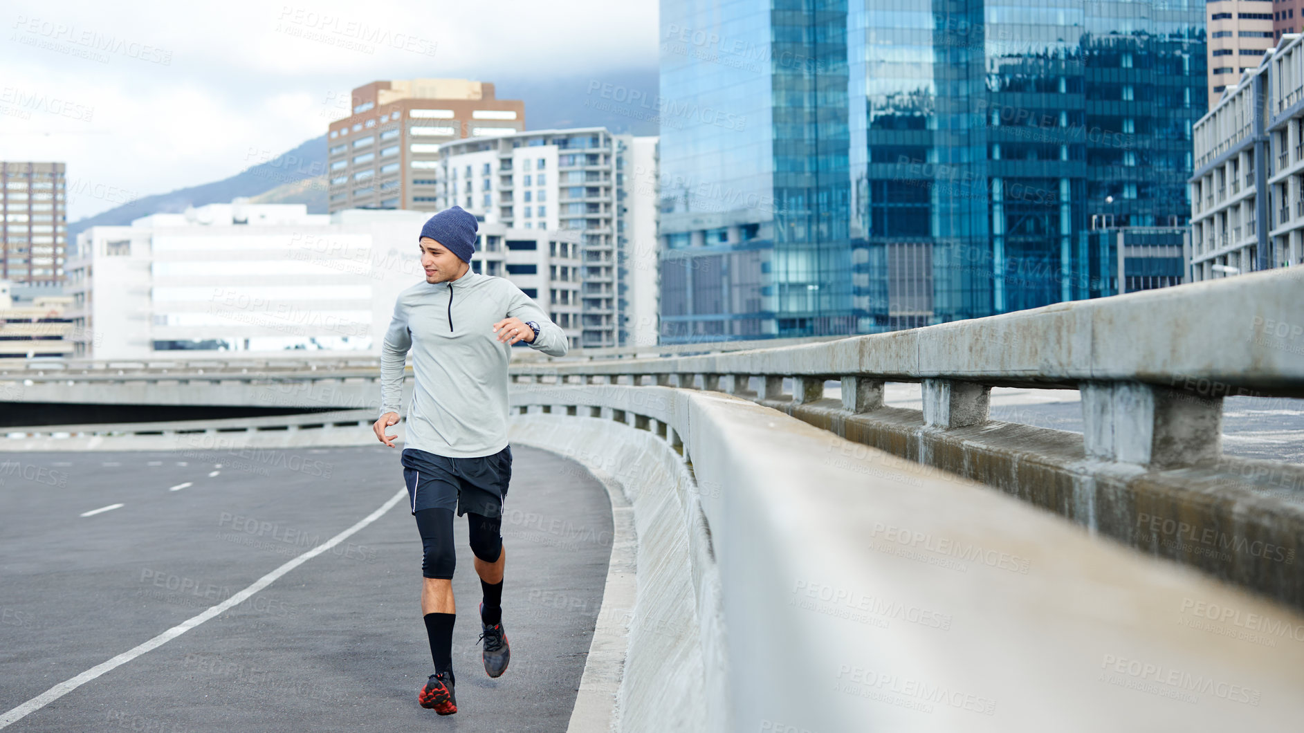 Buy stock photo Fitness, running and man in city for exercise, training or cardio for healthy body. Sports, jog and runner on street outdoor for wellness, energy or workout to lose weight or race in winter on bridge