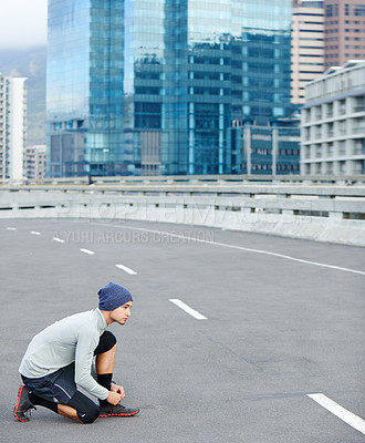 Buy stock photo Athlete, man or tie sneakers in city for morning jog, fitness or getting ready for cardio workout in street. Runner, person or prepare running shoes on urban bridge for exercise, training or marathon