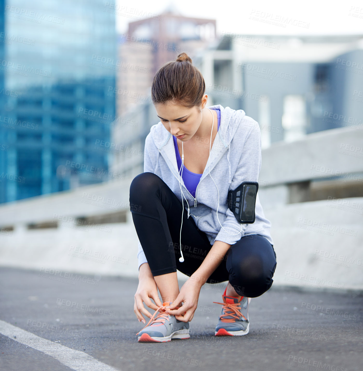 Buy stock photo Runner, fitness and tying shoes in city for running, sports or training on street or road. Health, jogging and woman or female athlete getting ready for exercise, marathon or cardio with music