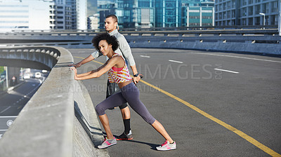 Buy stock photo Fitness, bridge and couple stretching in city for running with race, marathon or competition training. Sports, road and young man and woman athletes with warm up exercise for cardio workout in town.