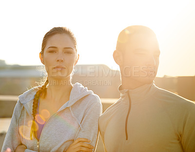 Buy stock photo Runner, woman and man in city at sunrise, portrait and arms crossed for fitness, training and health in morning. People, pride and workout on metro road for exercise, teamwork and ready for marathon