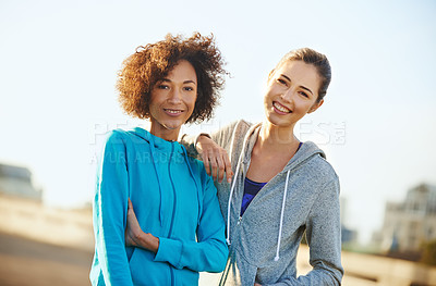 Buy stock photo Portrait of two female joggers standing in the road before a run through the city