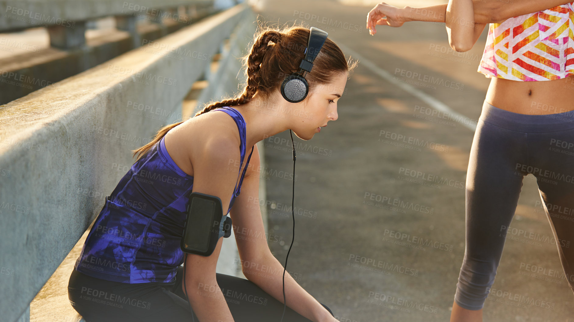 Buy stock photo Girl, headphones and runner relax in city, stretching arms and streaming music for cardio warm up. Female person, fitness rest and urban street for workout wellness, town and listen to podcast audio