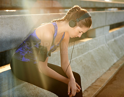 Buy stock photo Girl, headphones and runner break in city, thinking and streaming music for mindfulness cardio. Female person, fitness rest and urban street for workout wellness, town and listening to podcast audio