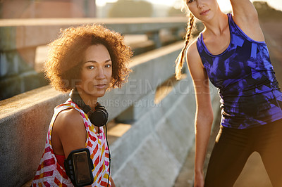 Buy stock photo Portrait of two female joggers preparing for a jog in the city