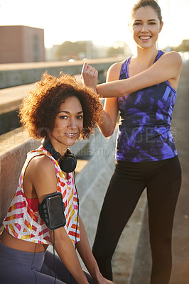 Buy stock photo Portrait of two female joggers preparing for a jog in the city