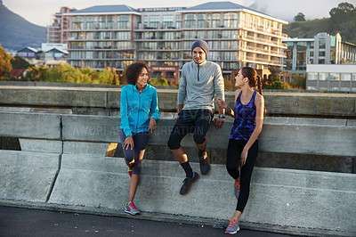 Buy stock photo Friends, break and rest in city for fitness, exercise and running session for marathon challenge outdoor. Bridge, man and women with discussion for wellness goals, jog experience and bonding together