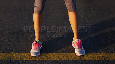 Buy stock photo Cropped shot of a runner's legs standing on the street