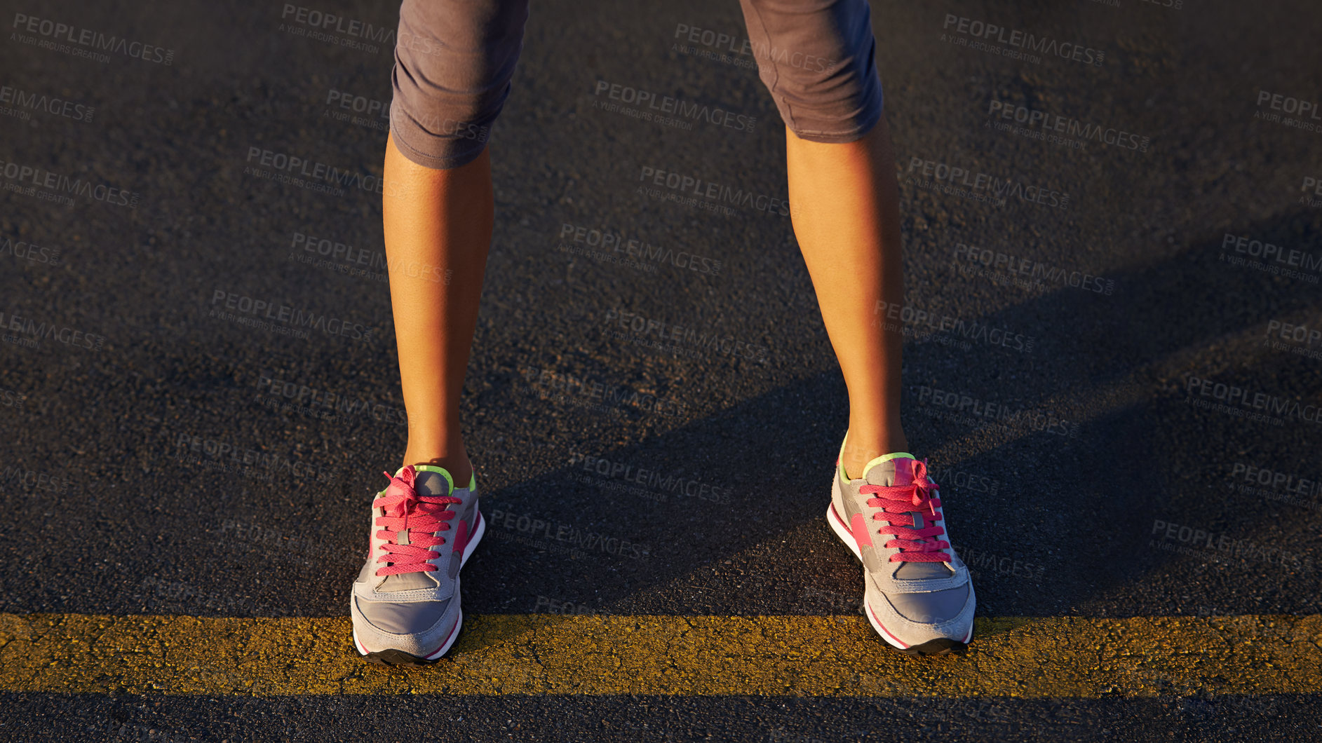 Buy stock photo Cropped shot of a runner's legs standing on the street