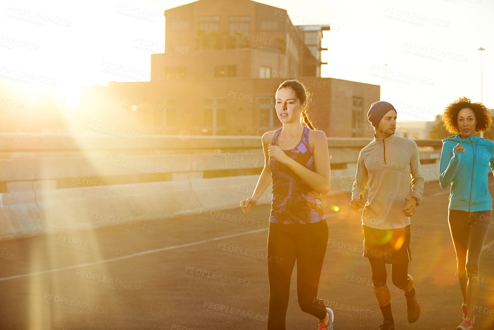 Buy stock photo Urban, people and running on road at sunset for fitness, training and commitment to healthy body. Evening, exercise and friends on street for city workout, outdoor challenge or sports performance