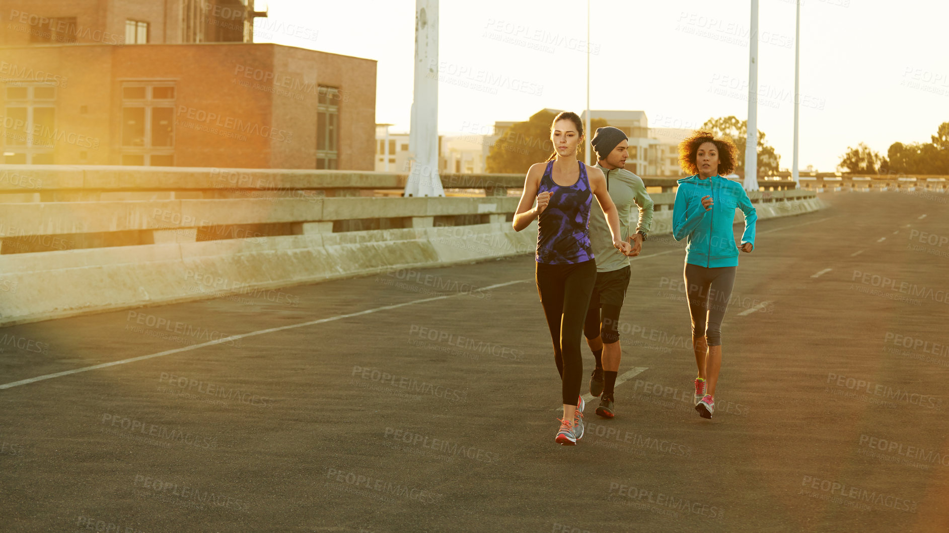 Buy stock photo People, friends and running on road for fitness with training, support and care in California. Workout, exercise and city with jogging for health or wellness and wellbeing in sportswear in lens flare