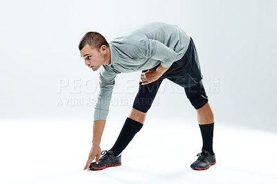 Buy stock photo Fitness, man and stretching legs in studio for body wellness, warm up exercise or getting ready for workout. Athlete, person or flexible on white background mockup with training, preparing or balance