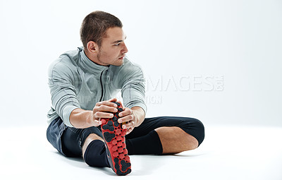 Buy stock photo Workout, man or stretching legs in studio for body wellness, warm up exercise or getting ready for fitness. Athlete, thinking or flexible on white background mockup with training or activity on floor