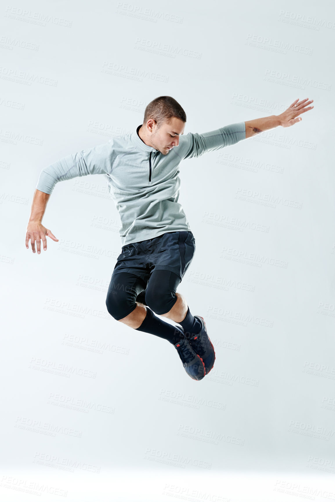 Buy stock photo Man, jump and fitness with energy in studio for healthy body, workout and muscle strength. Person, sports and athlete in air by white background for performance, challenge and exercise for self care