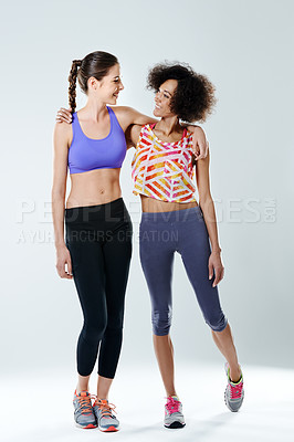 Buy stock photo Fitness, women and smile with hug in studio for workout support, teamwork and training partner. Gym, athlete and happy with friends by white background for exercise, collaboration and sports together