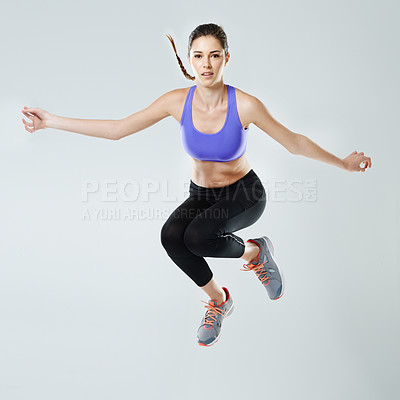 Buy stock photo Fitness, woman and jump with portrait in studio for healthy body, exercise and muscle strength. Person, sports and athlete in air with workout for training, energy and self care by white background