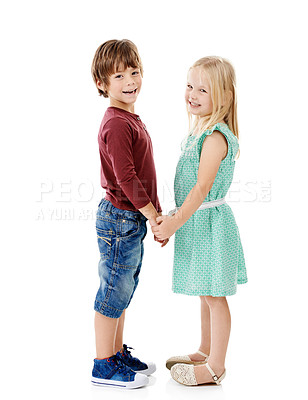 Buy stock photo Studio shot of a cute little boy and girl holding hands against a white background