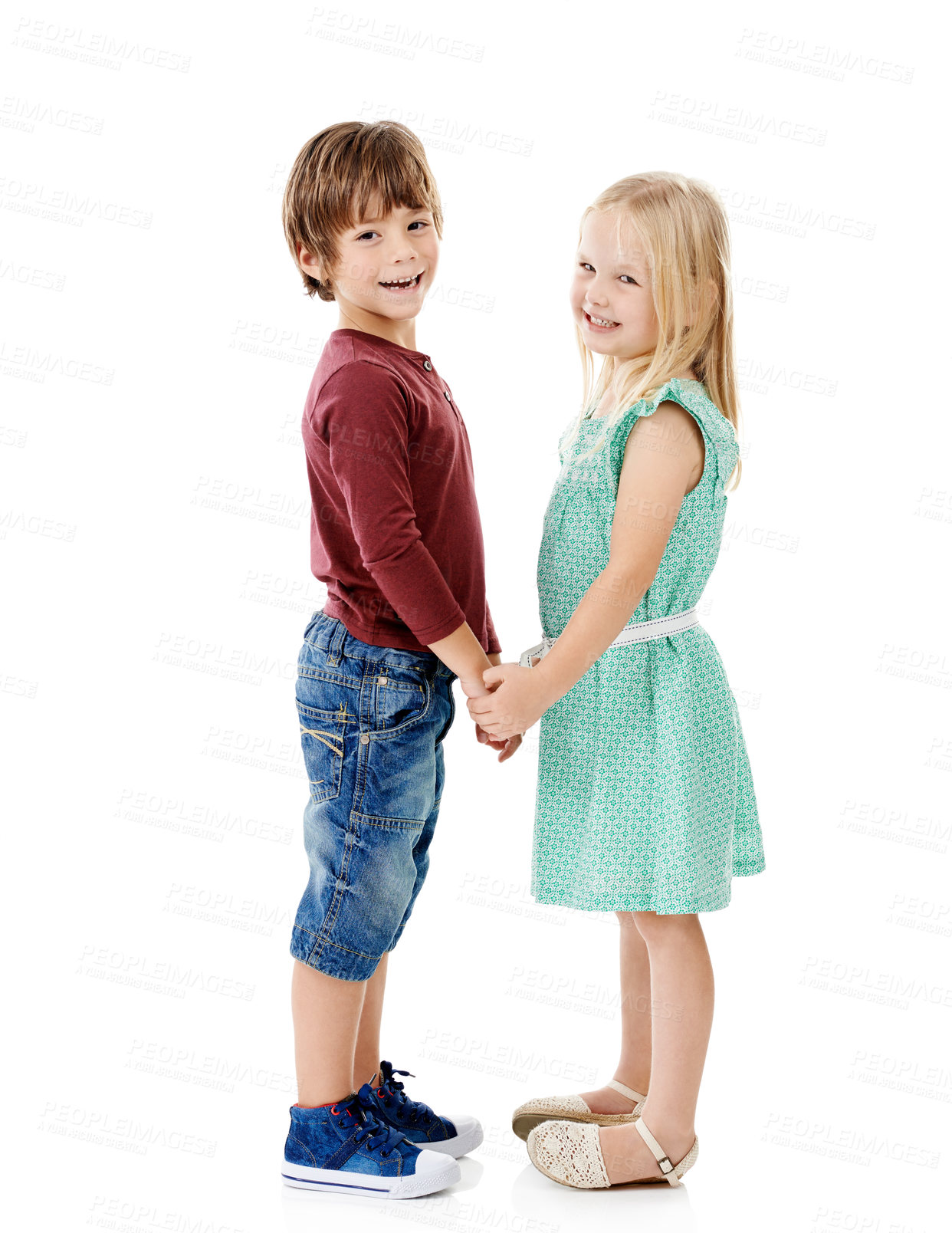 Buy stock photo Children, brother and sister in studio for holding hands with smile, care and bonding by white background. Kids, boy and girl in portrait, connection and happy for love, family and fashion in France