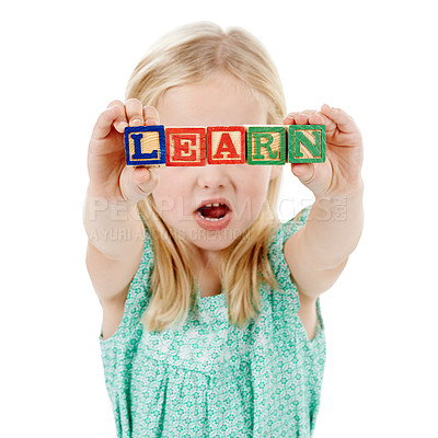 Buy stock photo Building blocks, learning and kid in studio for creative skills, education and development. Kindergarten, childhood and isolated young girl with school toys for spelling games on white background