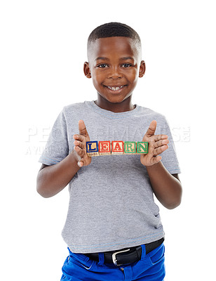 Buy stock photo Studio shot of a cute little boy holding building blocks that spell the world 'learn' against a white background