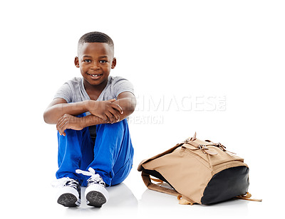 Buy stock photo Kid, boy and portrait with backpack in studio for back to school, mockup space or happy for education on floor. Student, black child and smile with schoolbag for learning or study on white background