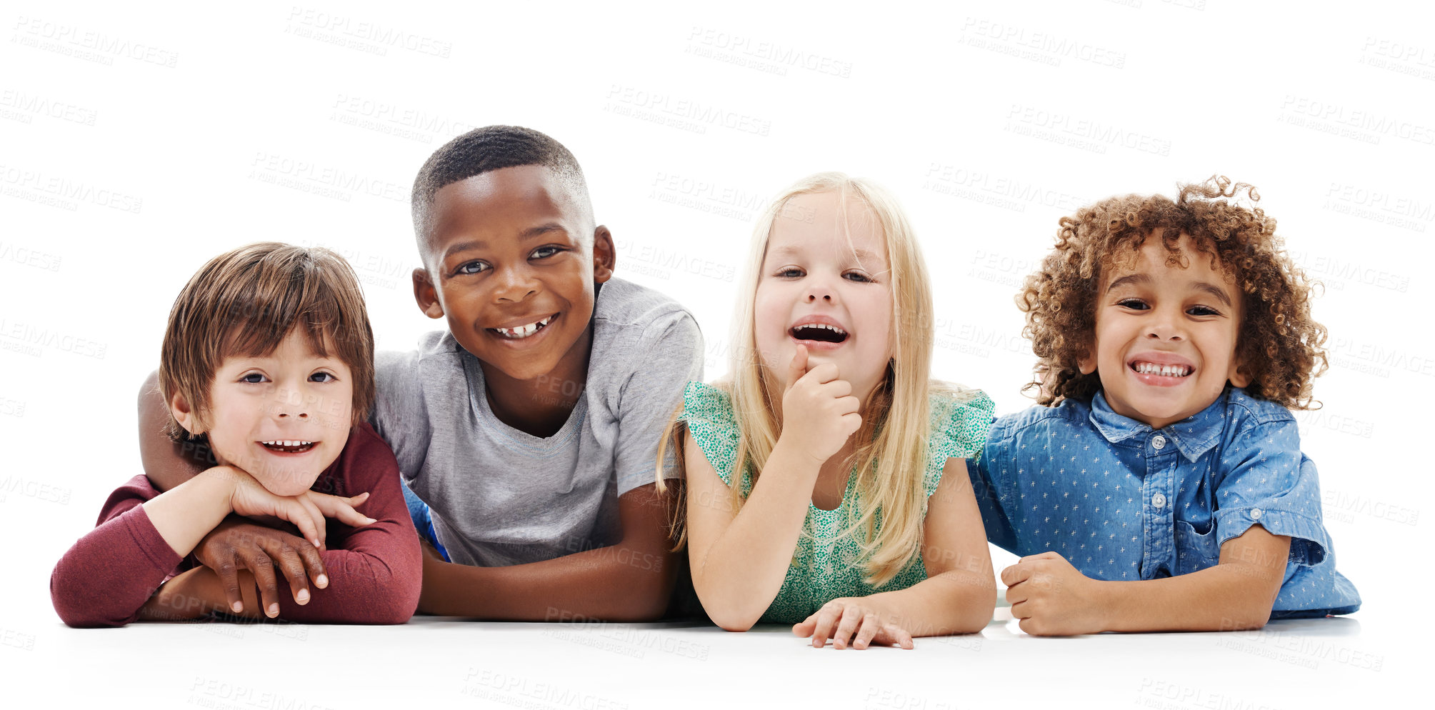 Buy stock photo Studio shot of a group of young friends lying on the floor together against a white background